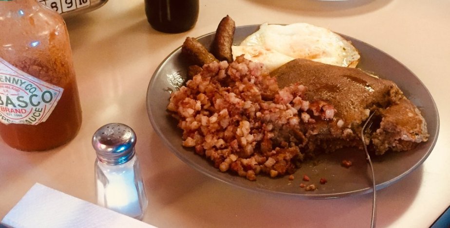  I met a dude who wolfed down this awesome-looking plate of goodness (Buckwheat pancakes drenched in maple syrup, corned beef hash, two breakfast sausages, and two eggs over easy) in TEN minutes! Well done, sir! Well done.  